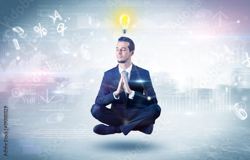 Foto Businessman meditates with enlightenment concept