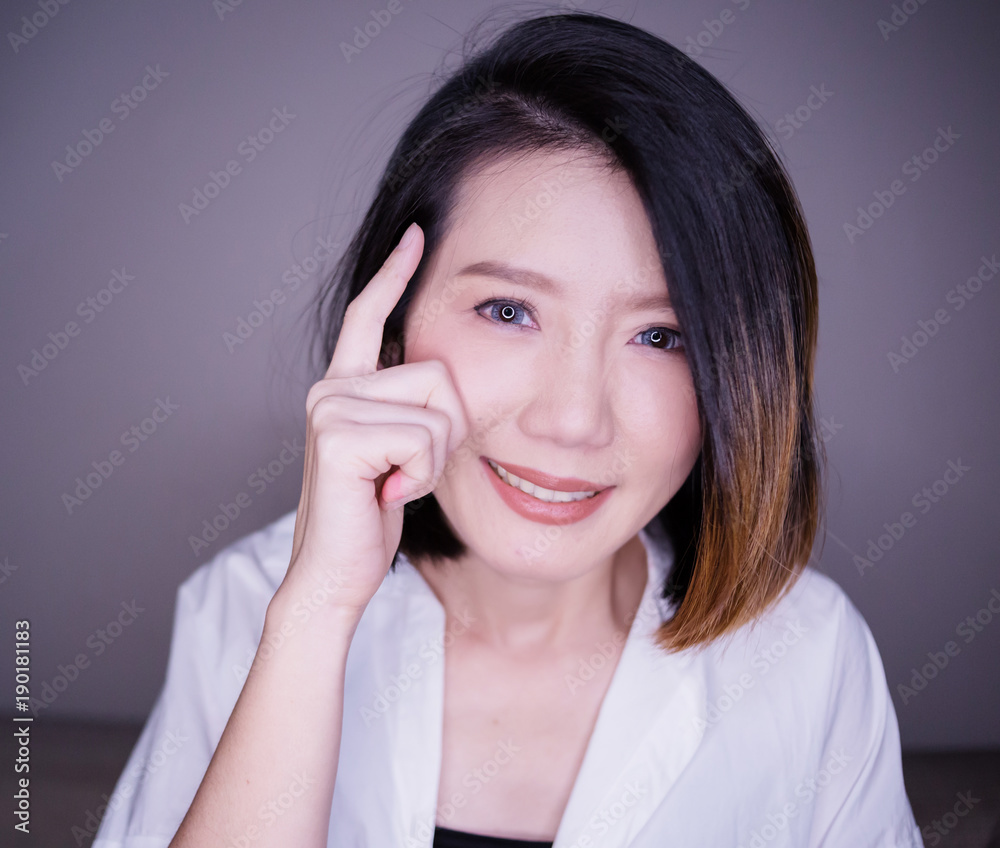 beautiful asian woman white shirt with thinking action pose high contrast lighting image beautiful asian woman white shirt with thinking action pose high contrast lighting image