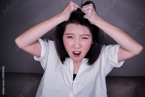 beautiful asian woman hand hold her hair with stressful emotion problem concept