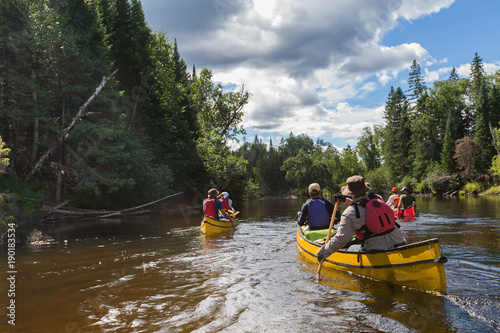 Obraz na płótnie Group of people paddling the whitewater of the Noire River in Quebec, Canada. w salonie
