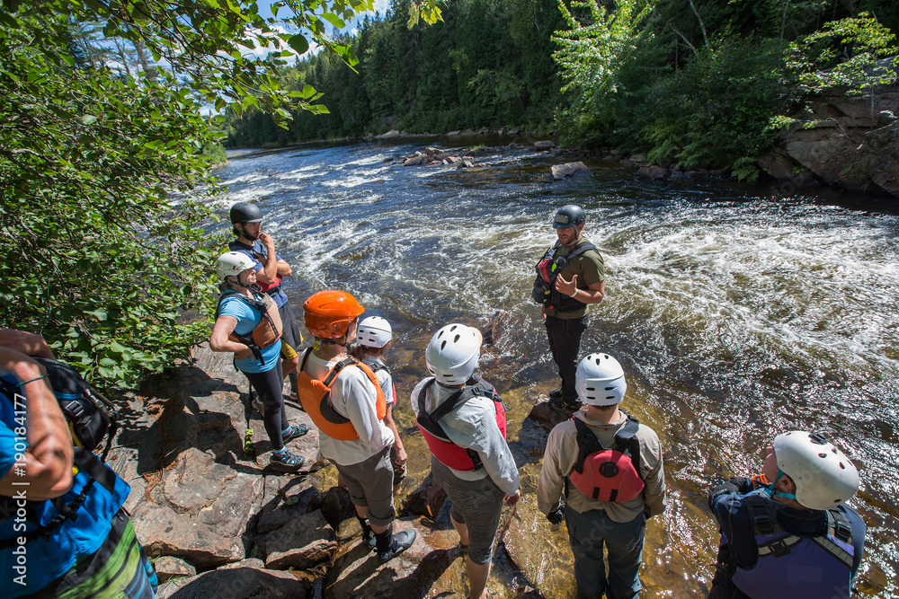 Canoeist stuck in a hole on the rapids of the Noire River, Quebec, Canada.