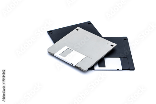 Three old retro computer disks on isolated white background. 