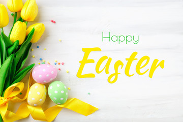 Happy Easter. Congratulatory easter background. Easter eggs and flowers.