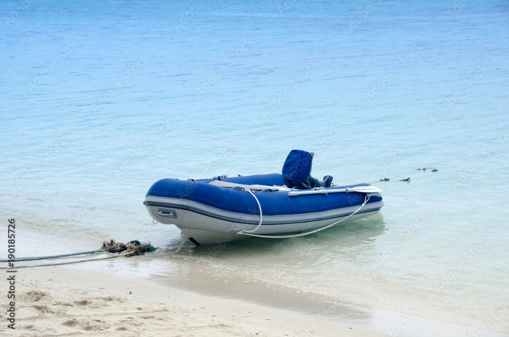 inflatable motor boat on the beach in sunny day inflatable motor boat on the beach in sunny day