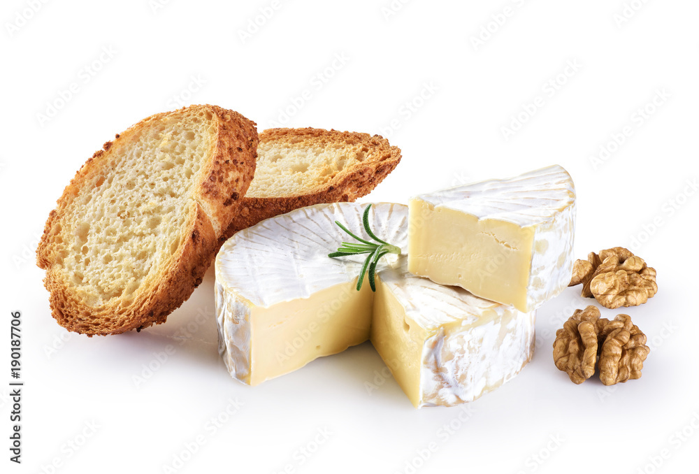 Camembert cheese, toasts, rosemary and walnuts isolated on white background.