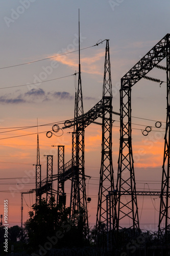 High voltage power plant at sunset