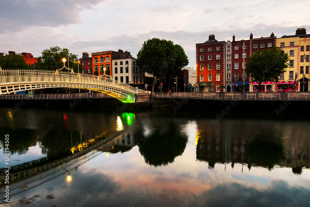 Morning view of famous illuminated Ha Penny Bridge in Dublin, Ireland