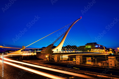 Samuel Becket Bridge at sunset in Dublin, Ireland. Beautiful architecture and illuminated hotels