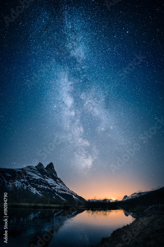 Fotografiet Beautiful view of milky way glowing on the sky with mountains and river and refl