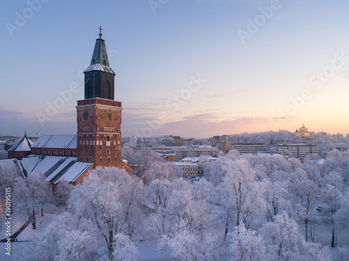 Aerial view of Turku Cathedral at winter evening with beautiful frosty trees on foreground, Finland photo