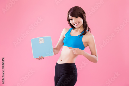 sport woman take weight scale