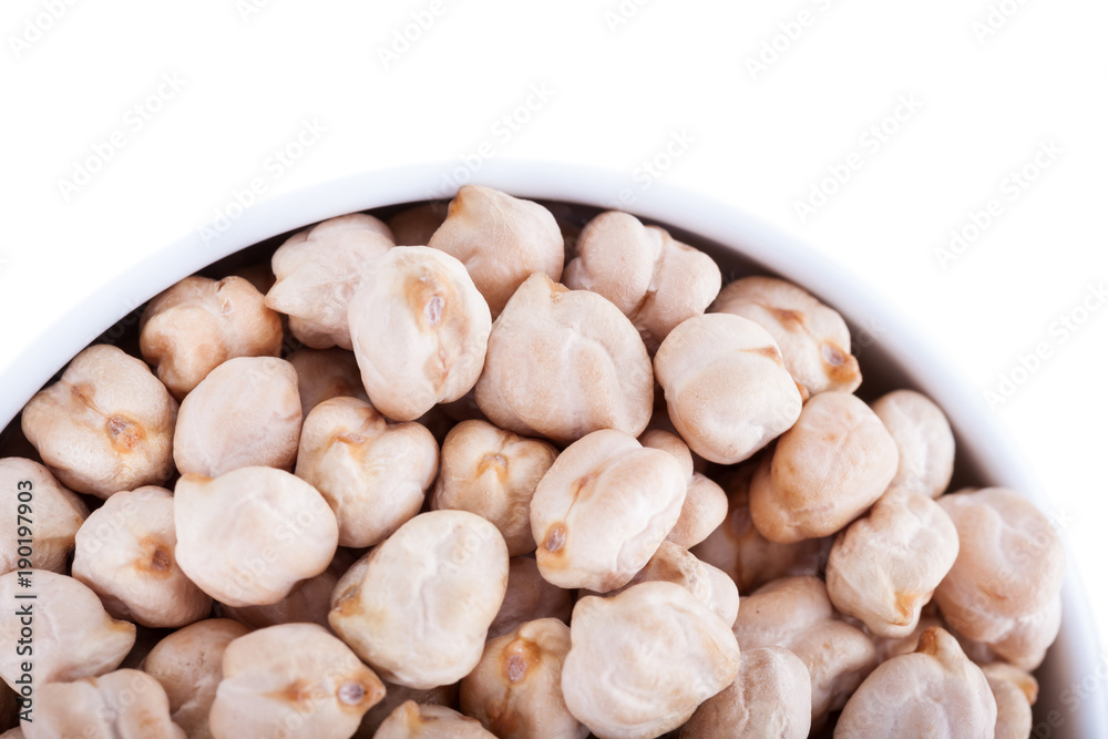 Raw dry chickpeas in bowl on white background