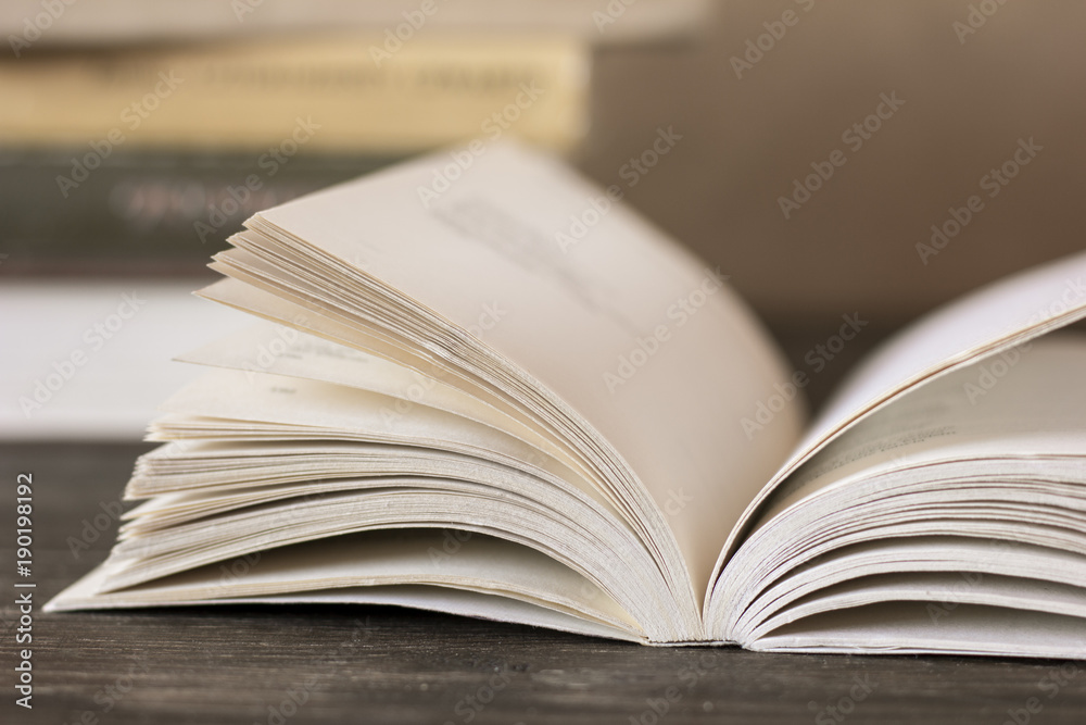 Open book on wooden desk Open book on wooden desk