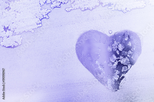 Heart shape symbol on Frozen window glass