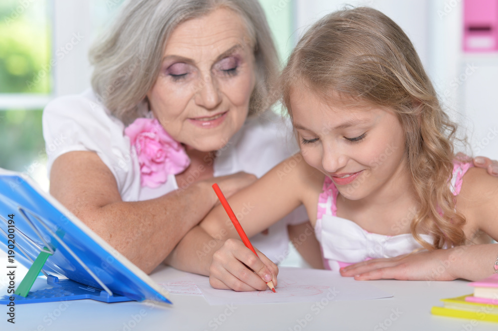 grandmother and granddaughter doing homework grandmother and granddaughter doing homework