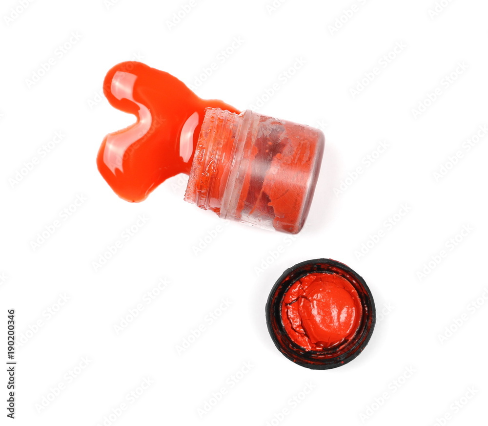 Fototapeta premium Spilled red watercolor with bottle isolated on white background, top view