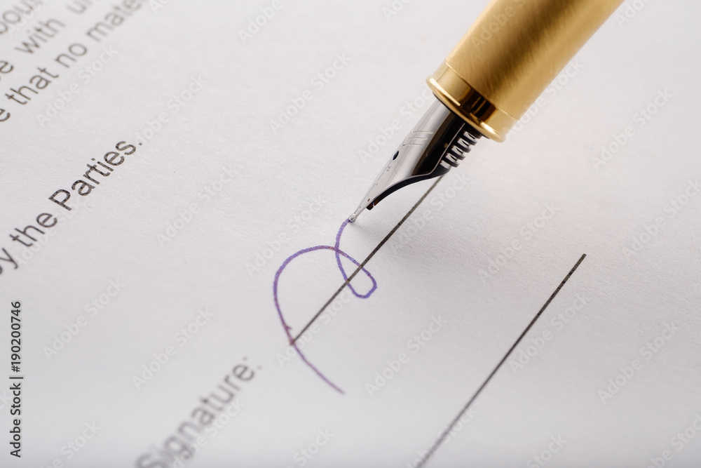 Fototapeta premium Close-up of gilded fountain pen signing contract, document.
