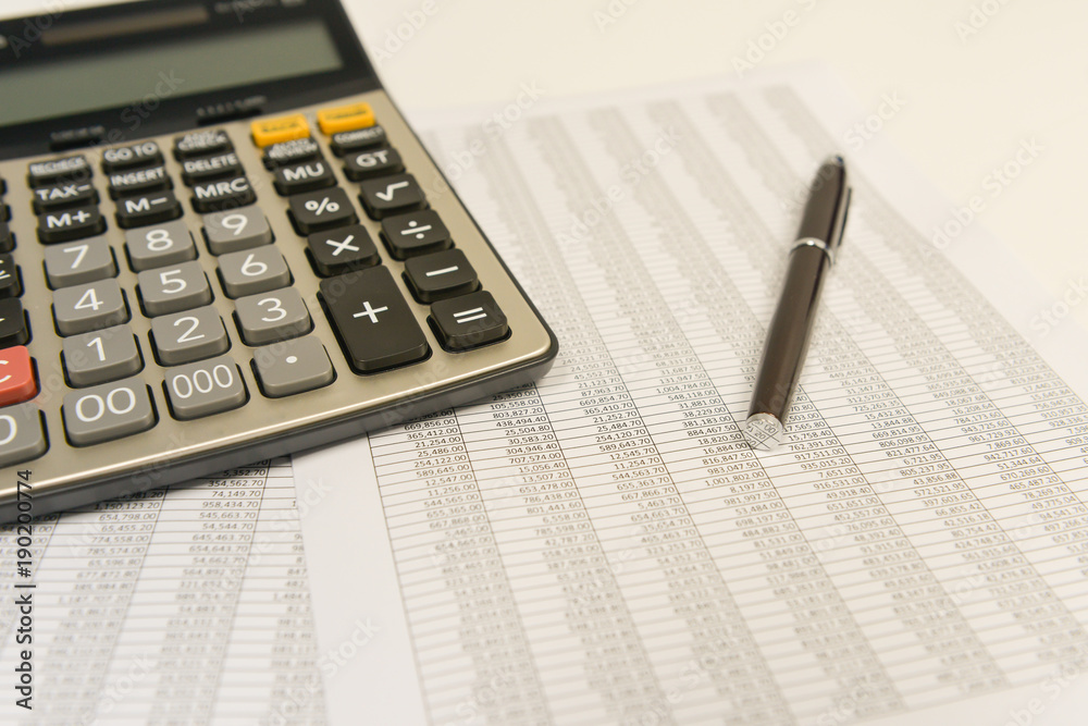 Calculator and pen are on the accounting documents Calculator and pen are on the accounting documents