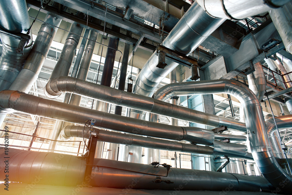 Fototapeta premium Industrial Steel pipelines, valves, cables and walkways