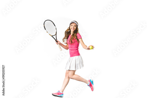 sporty girl playing tennis and smiling at camera isolated on white