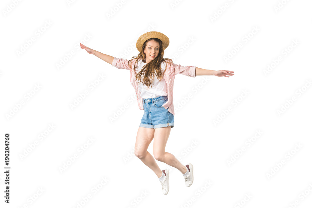 happy girl in hat jumping with open arms and smiling at camera isolated on white happy girl in hat jumping with open arms and smiling at camera isolated on white