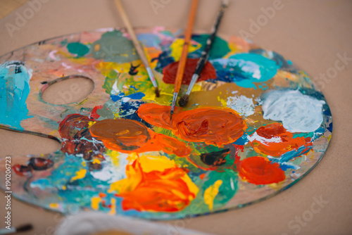 close-up shot of oil painting palette with brushes