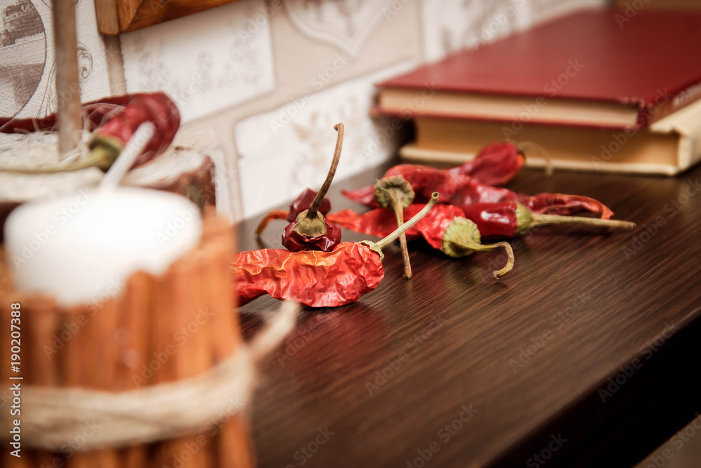 Chili Peppers. Vintage Style. Old Fashion Kitchen Shelf Background with Old Books. toned.