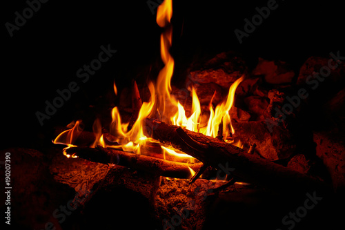 Flame on a black background in natural conditions at night.