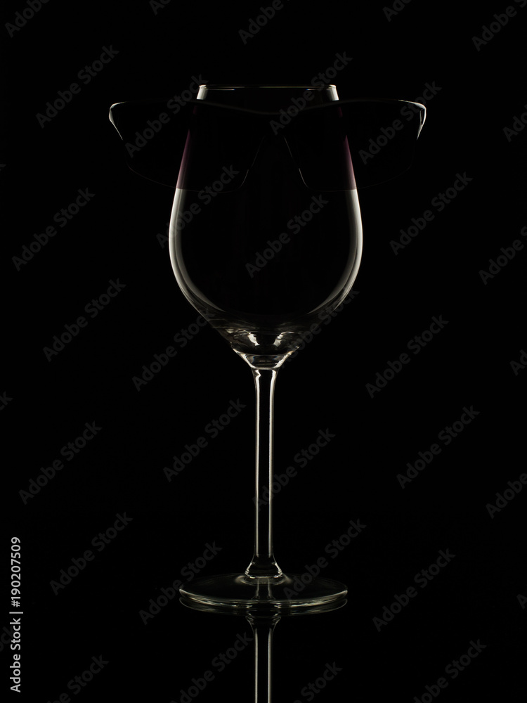 sunglasses on a glass for wine
