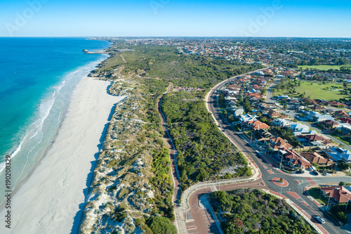 aerial coastline views of sandy white beach to the horizon 