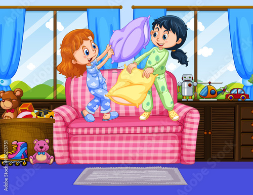 Two girls in pajamas playing pillow fight in room