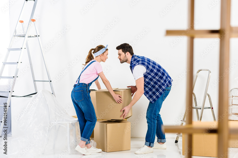 boyfriend and girlfriend taking box and looking at each other boyfriend and girlfriend taking box and looking at each other