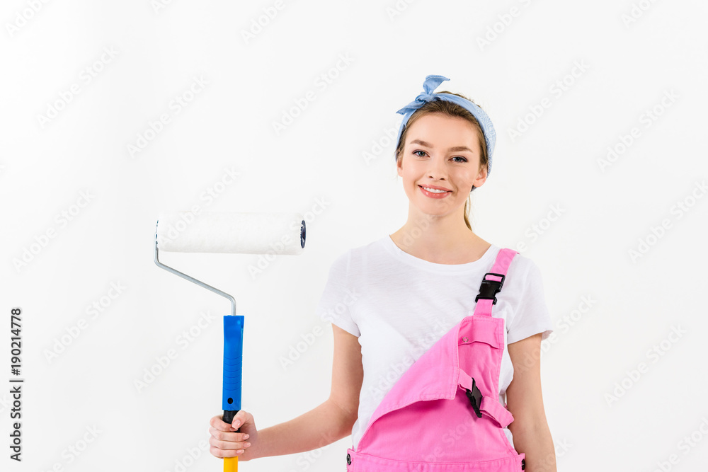 smiling girl standing with paint roller brush smiling girl standing with paint roller brush