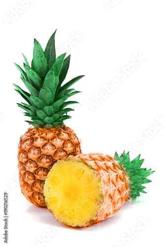 ripe pineapple whole and half isolated on white background