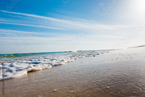 Calm sea and surf on a sandy beach. summer sea in Sunny weather with blue sky. Beautiful sandy beach and transparent waves