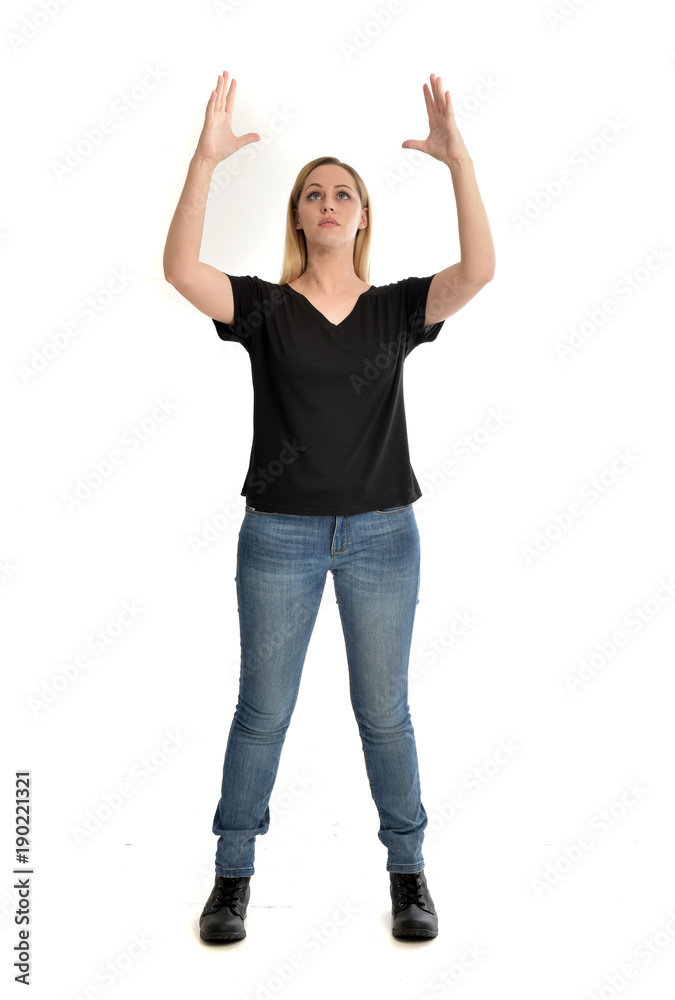 full length portrait of blonde girl wearing black shirt and jeans, standing pose isolated on a white background. full length portrait of blonde girl wearing black shirt and jeans, standing pose isolated on a white background.