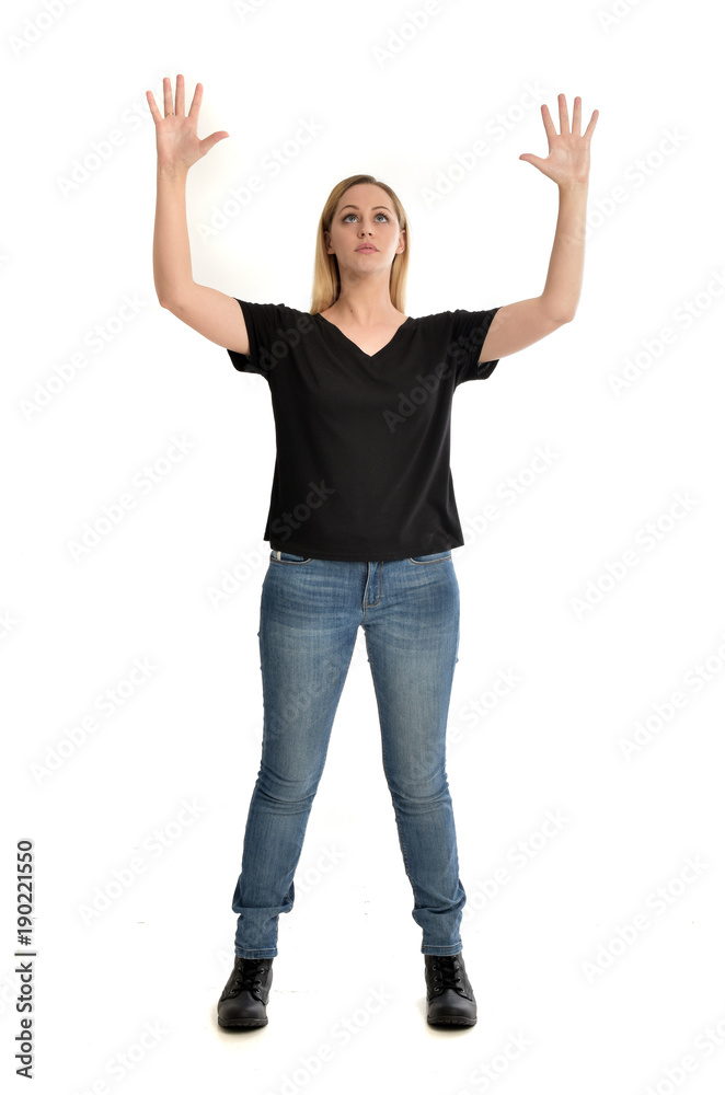 full length portrait of blonde girl wearing black shirt and jeans, standing pose isolated on a white background. full length portrait of blonde girl wearing black shirt and jeans, standing pose isolated on a white background.