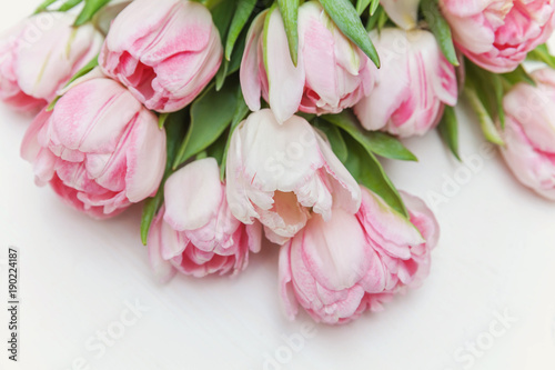 Bouquet of pink tulips over shabby white wooden table. Spring greeting card happy mother day copy space