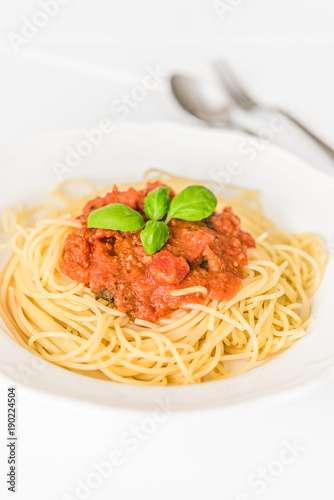 tatsty fresh spaghetti with tomato sauce fresh basil isolated on white background