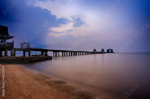 Old bridge in the sea on twilight time after sunset.