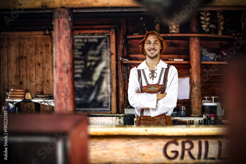 Bavarian man and his own small business. Grill bar interior. 