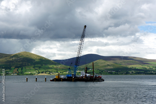 Floating platform with a crane against the background of the Mourne Mountains.Ireland.