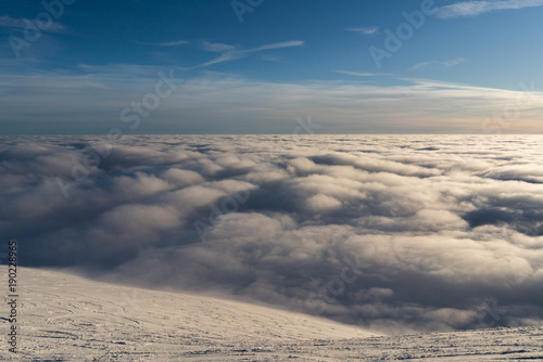 Beautiful sunset above clouds in snow covered Low Tatras mountains during susnet in winter