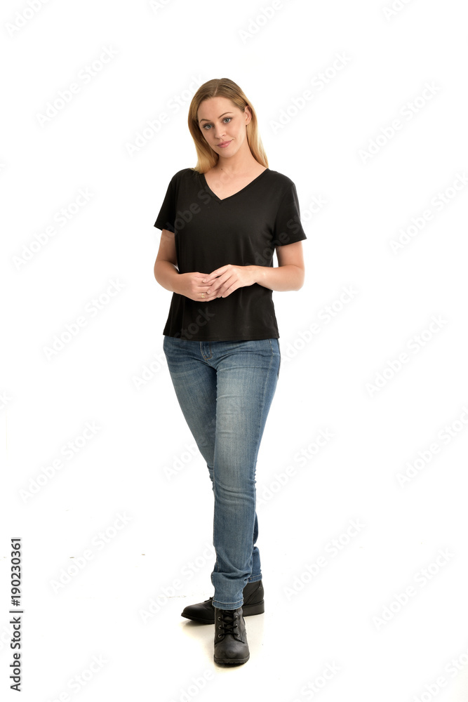 full length portrait of blonde girl wearing black shirt and jeans ...