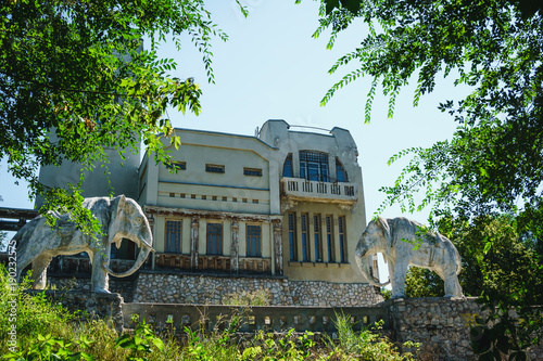 Abandoned cottage, house with statue of two elephants in Samara, Russia photo