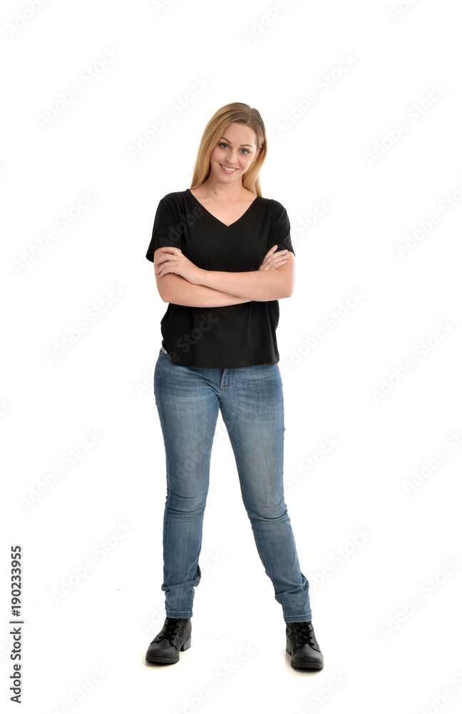 full length portrait of blonde girl wearing black shirt and jeans, standing pose isolated on a white background. full length portrait of blonde girl wearing black shirt and jeans, standing pose isolated on a white background.