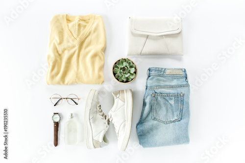 Woman clothes and accessories set on white background top view. modern and casual outfit. fashion, shopping and makeup concept. Flat lay, top view. 