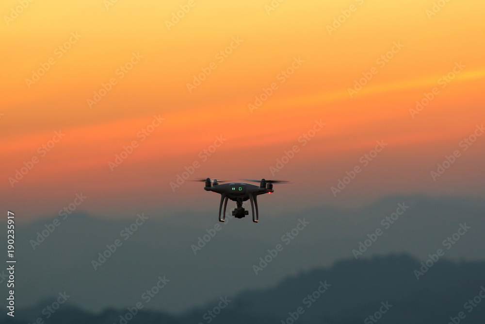 Silhouette drones.Drone flying in the sunset Silhouette drones.Drone flying in the sunset