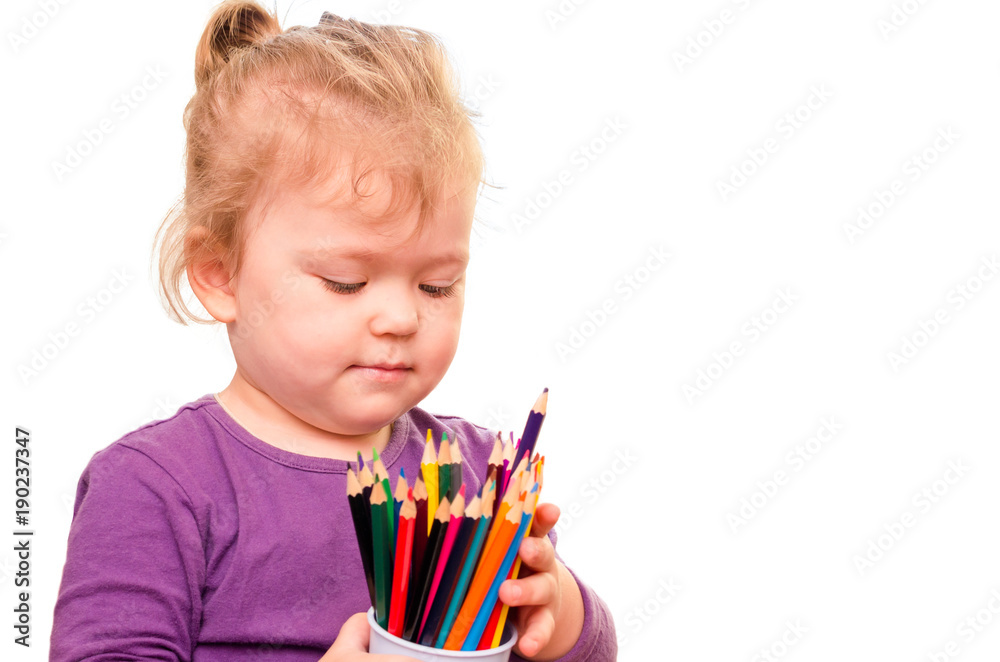 Little girl holding colored pencils in hands, isolated on white background Little girl holding colored pencils in hands, isolated on white background