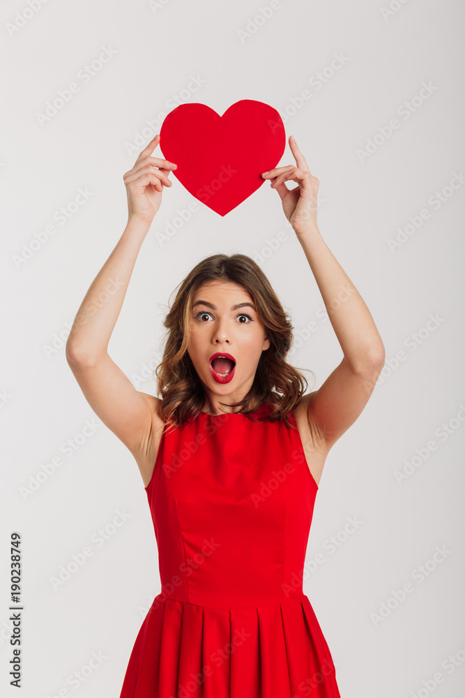 Portrait of a surprised young woman dressed in red dress Portrait of a surprised young woman dressed in red dress